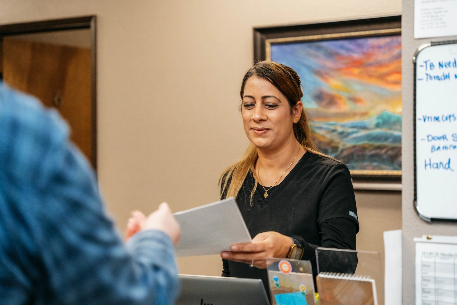 Patient being welcomed at an EveryDay Healthcare urgent care clinic reception