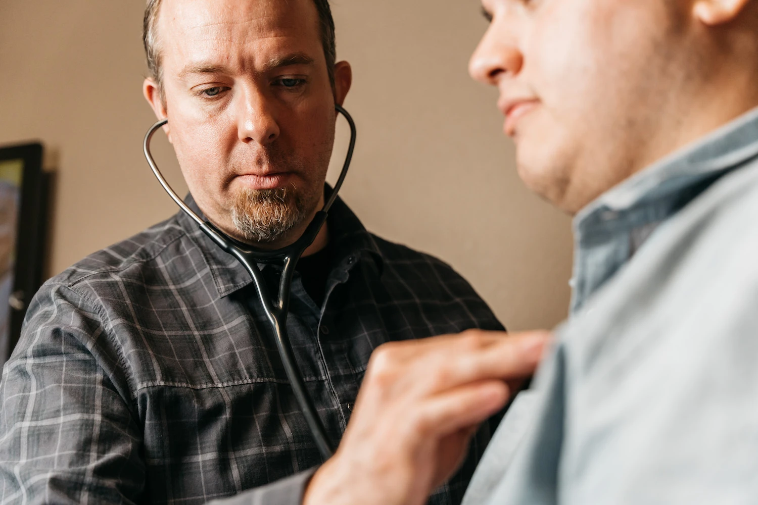 Provider listening to a patient's heartbeat with a stethoscope at EveryDay Healthcare